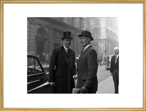 Three formally dressed men on a street flanked by high buildings. c.1955