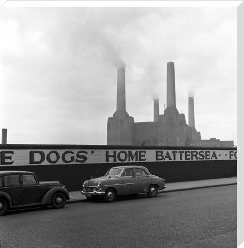 Two parked cars with Battersea Power Station in the background. c.1955