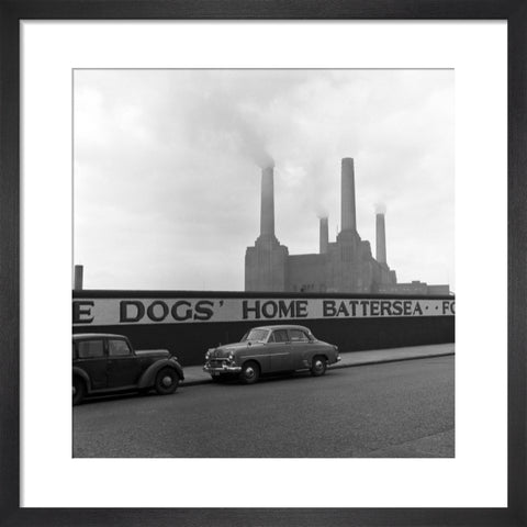 Two parked cars with Battersea Power Station in the background. c.1955