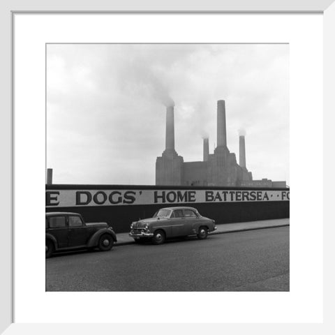 Two parked cars with Battersea Power Station in the background. c.1955