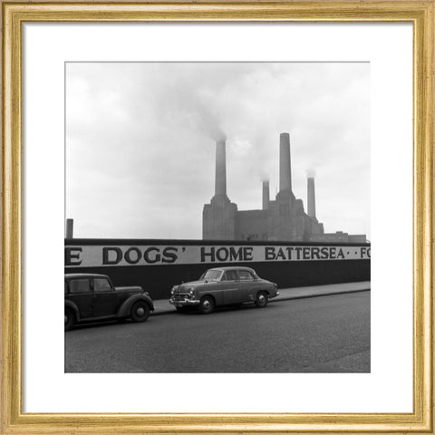 Two parked cars with Battersea Power Station in the background. c.1955