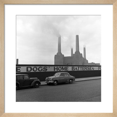 Two parked cars with Battersea Power Station in the background. c.1955