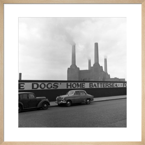 Two parked cars with Battersea Power Station in the background. c.1955