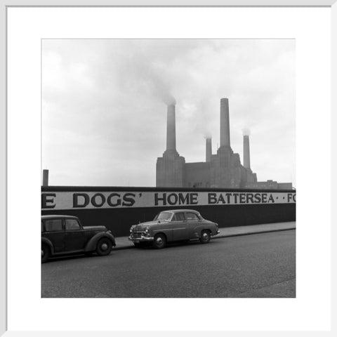 Two parked cars with Battersea Power Station in the background. c.1955