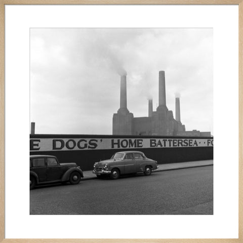 Two parked cars with Battersea Power Station in the background. c.1955