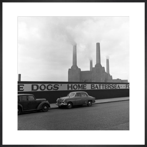 Two parked cars with Battersea Power Station in the background. c.1955