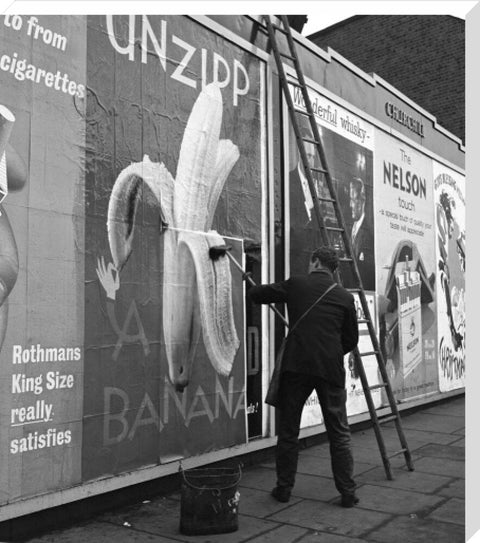 Man pastes up a billboard advertisement. c.1955