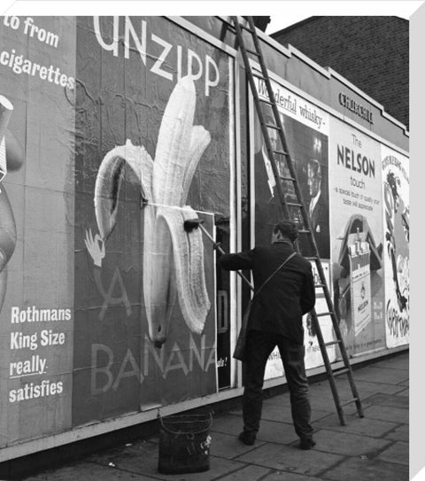 Man pastes up a billboard advertisement. c.1955