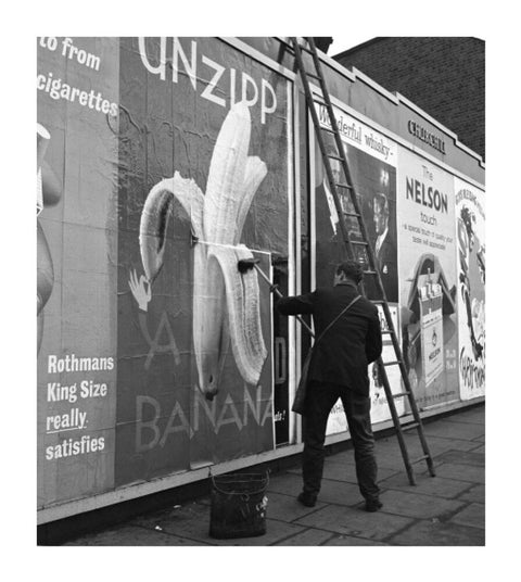 Man pastes up a billboard advertisement. c.1955