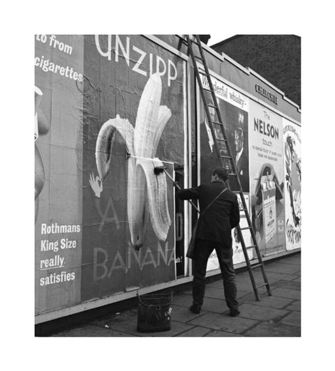 Man pastes up a billboard advertisement. c.1955