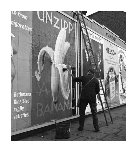 Man pastes up a billboard advertisement. c.1955