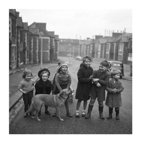 Children gathered in street with dog. c.1955