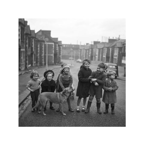 Children gathered in street with dog. c.1955