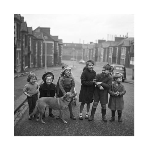 Children gathered in street with dog. c.1955