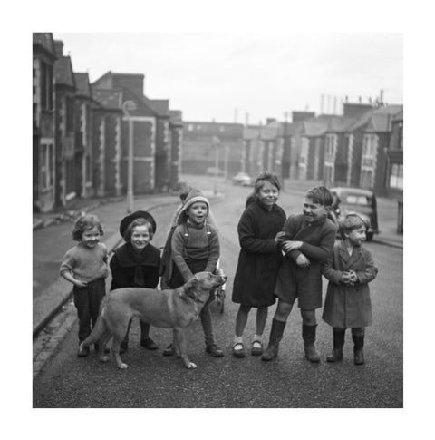 Children gathered in street with dog. c.1955