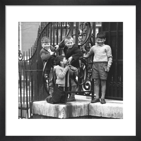 Four boys by railings. c.1955