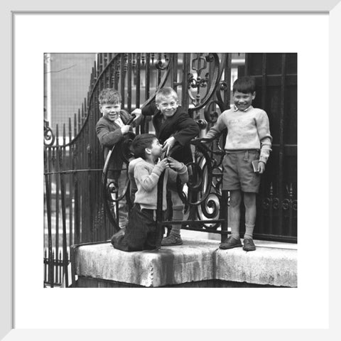 Four boys by railings. c.1955