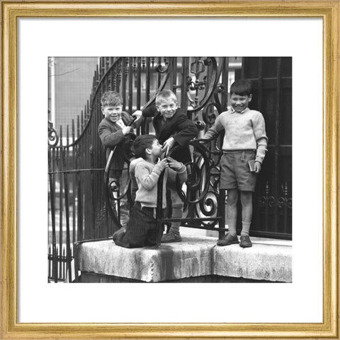 Four boys by railings. c.1955