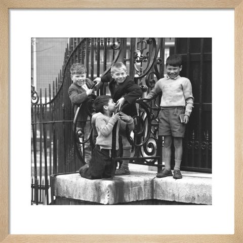 Four boys by railings. c.1955