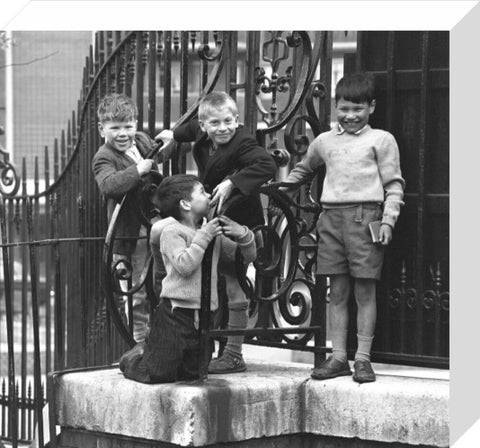 Four boys by railings. c.1955