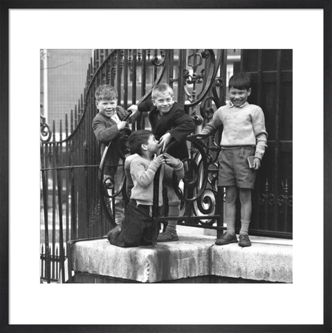 Four boys by railings. c.1955