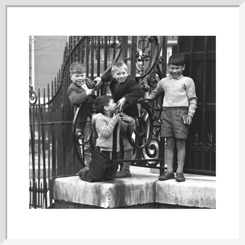 Four boys by railings. c.1955