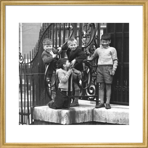 Four boys by railings. c.1955