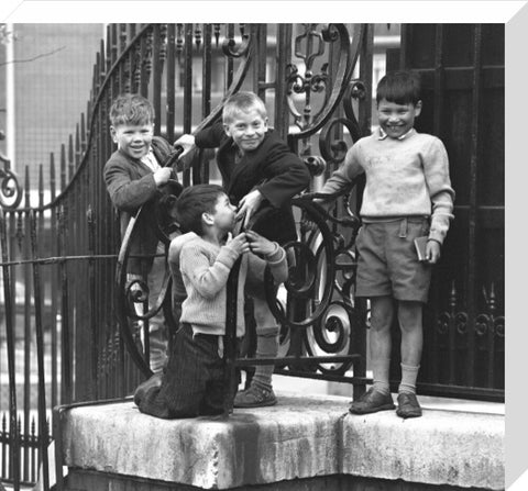 Four boys by railings. c.1955