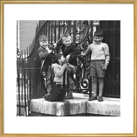 Four boys by railings. c.1955