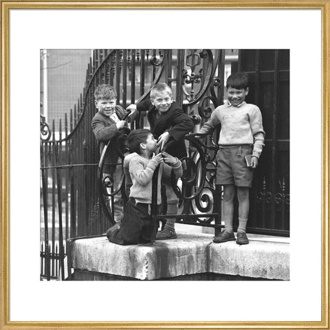 Four boys by railings. c.1955