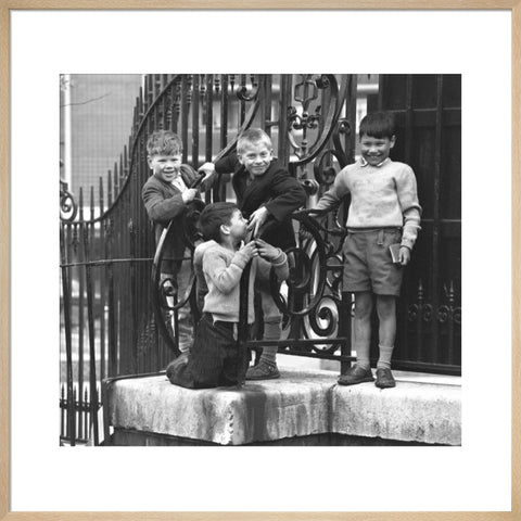 Four boys by railings. c.1955