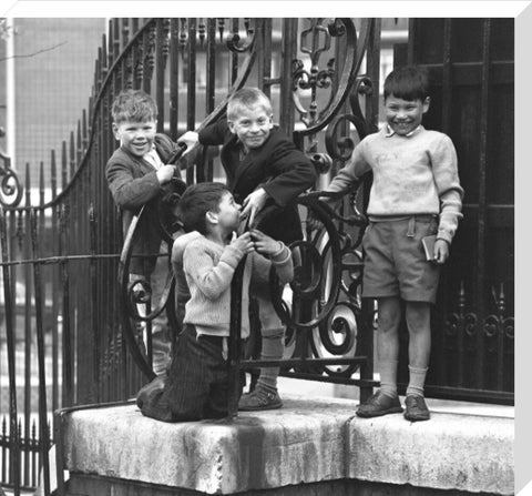 Four boys by railings. c.1955