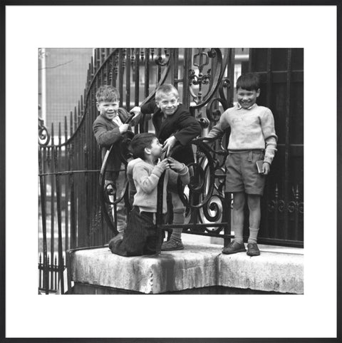 Four boys by railings. c.1955