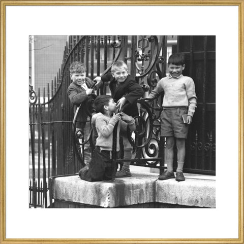 Four boys by railings. c.1955