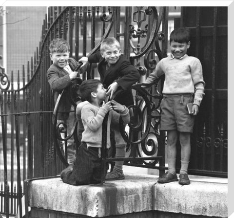 Four boys by railings. c.1955