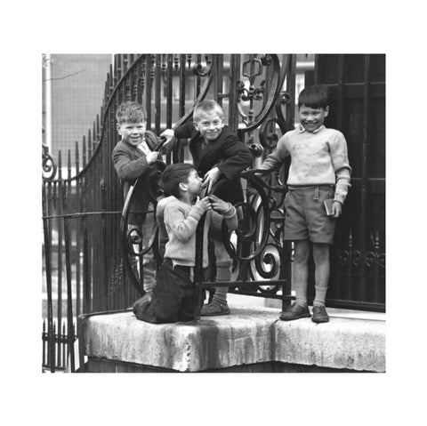 Four boys by railings. c.1955