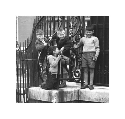 Four boys by railings. c.1955