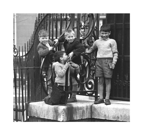 Four boys by railings. c.1955