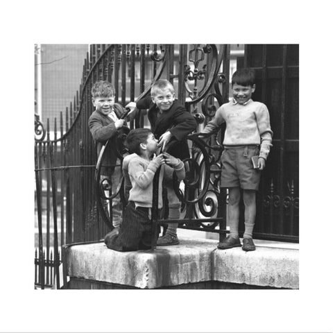 Four boys by railings. c.1955