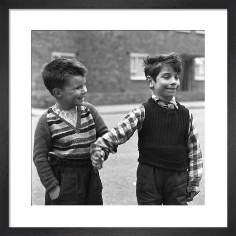 Two boys hold hands in street. c.1955