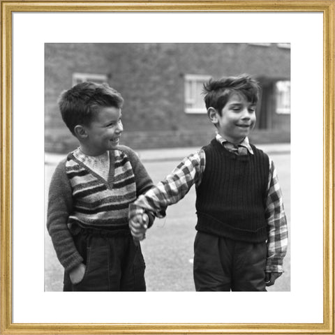 Two boys hold hands in street. c.1955