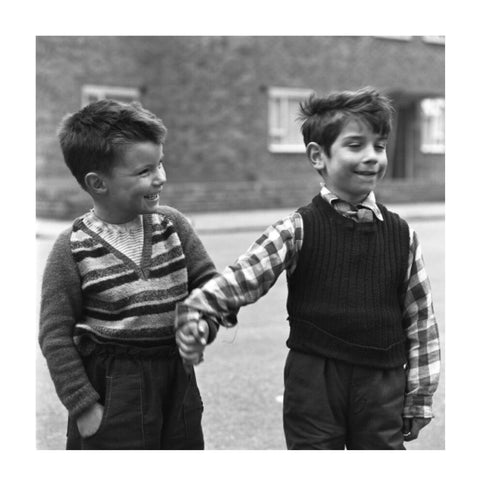 Two boys hold hands in street. c.1955