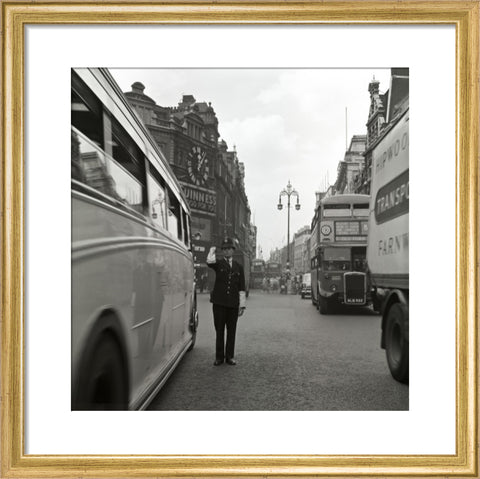 A policeman directing traffic New Oxford Street. c.1955