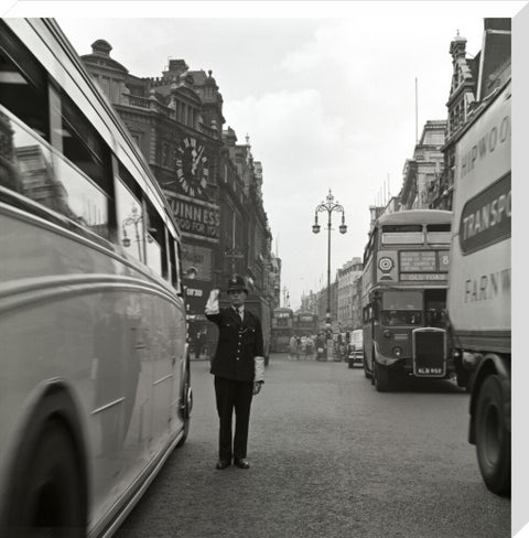 A policeman directing traffic New Oxford Street. c.1955