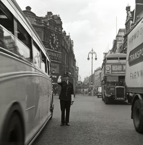 A policeman directing traffic New Oxford Street. c.1955