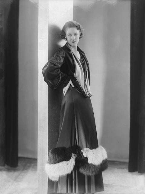 Image of a woman modeling a an evening coat 1932